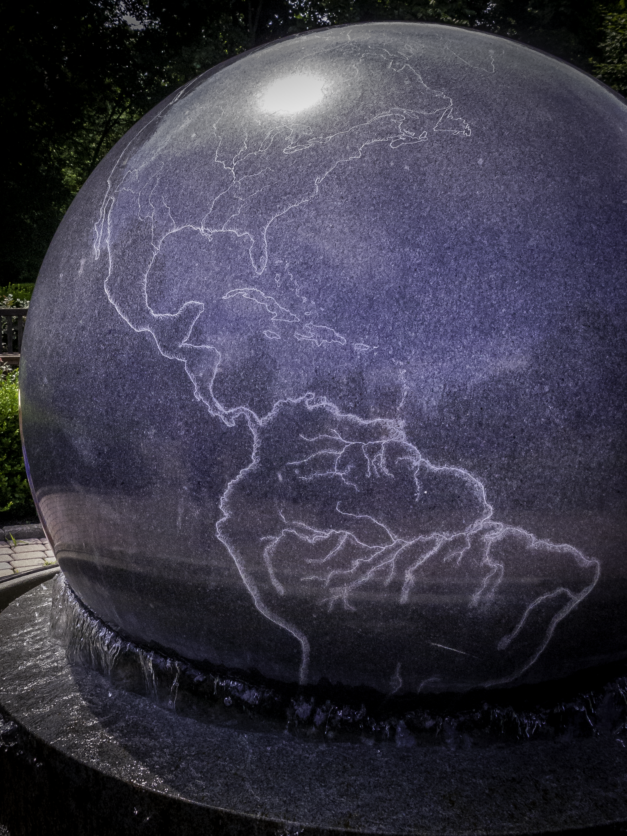Large granite sphere water fountain etched globe featuring North and South America at the Orange County Arboretum.