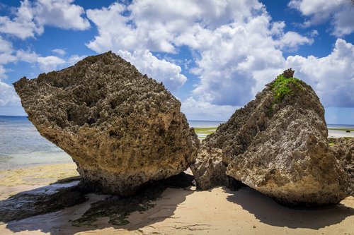 Fine art photography of ancient karst limestone rocks at Gun Beach, Guam, highlighting high-water lines and the tropical Pacific horizon.