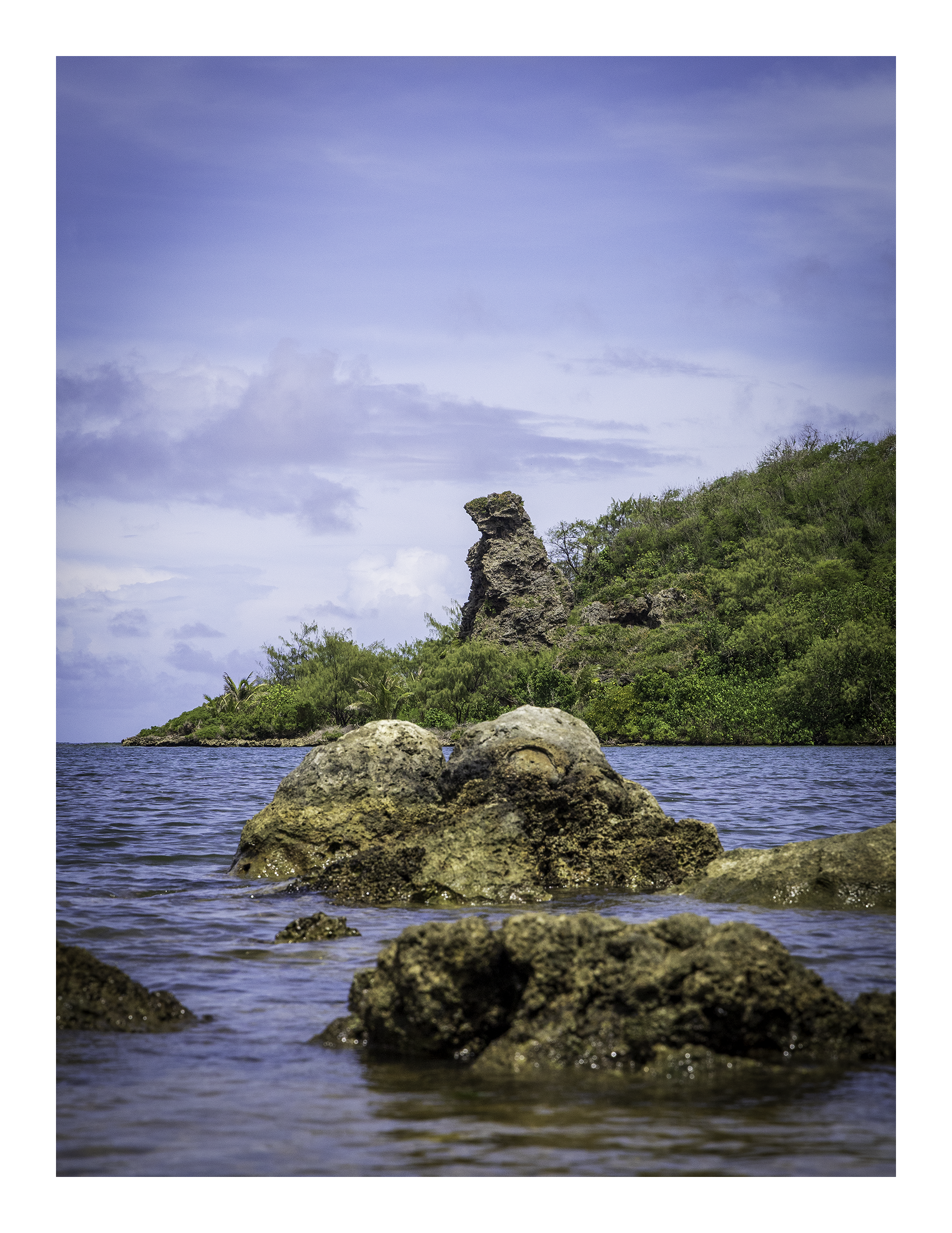A 17x22 inch fine art coastal photography print of Bear Rock in Guam, showing product dimensions and clean white border margins.
