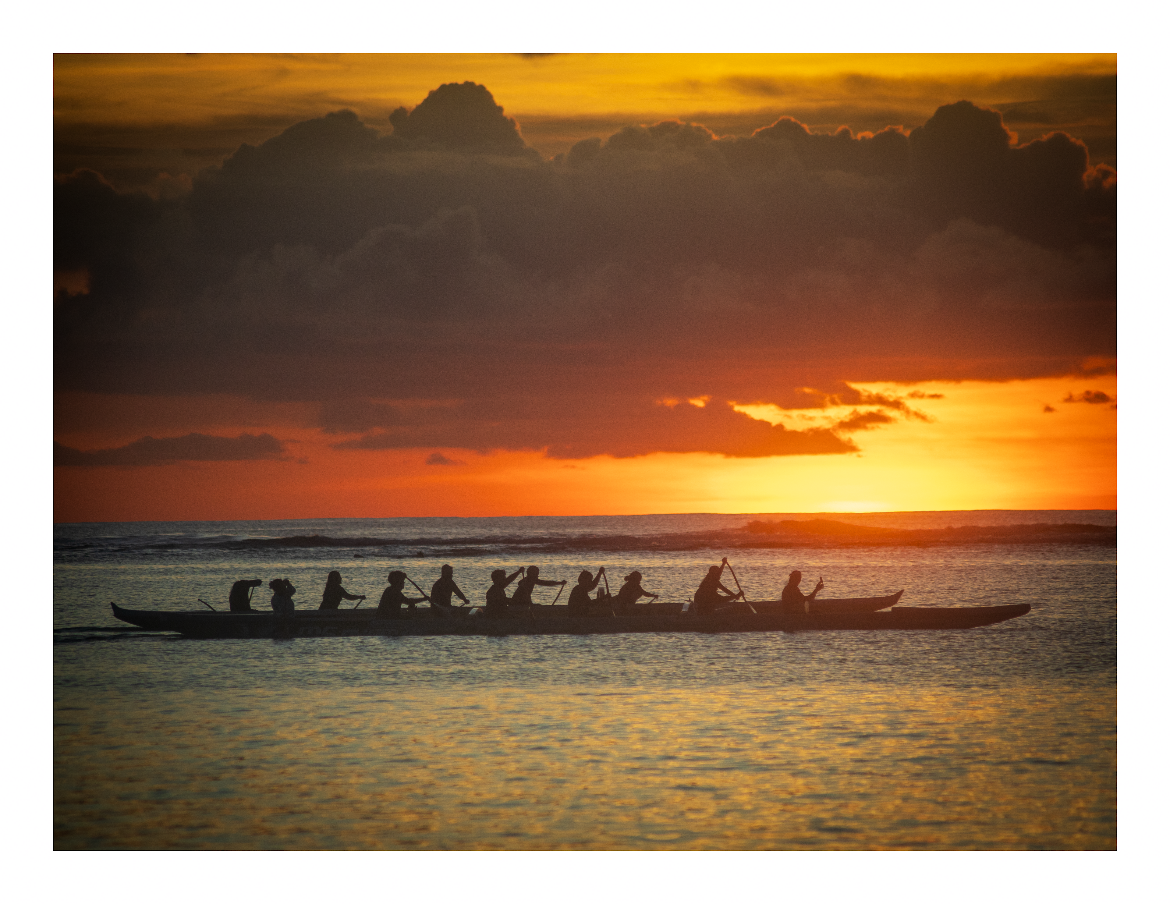 A 22x17 inch fine art print of an outrigger canoe at sunset, showing the product dimensions and clean white border margins.