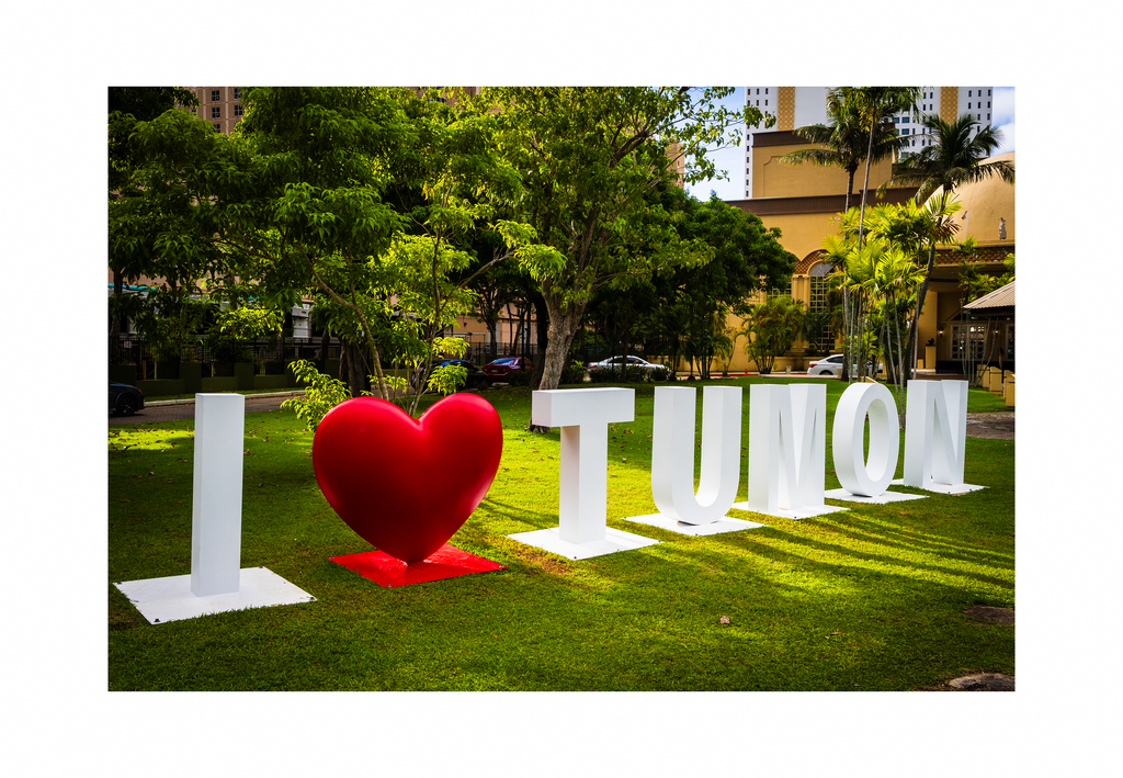 A 12x8 inch fine art travel print of the I Love Tumon landmark sign, showing product dimensions and clean white margins.