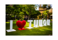 A 12x8 inch fine art travel print of the I Love Tumon landmark sign, showing product dimensions and clean white margins.