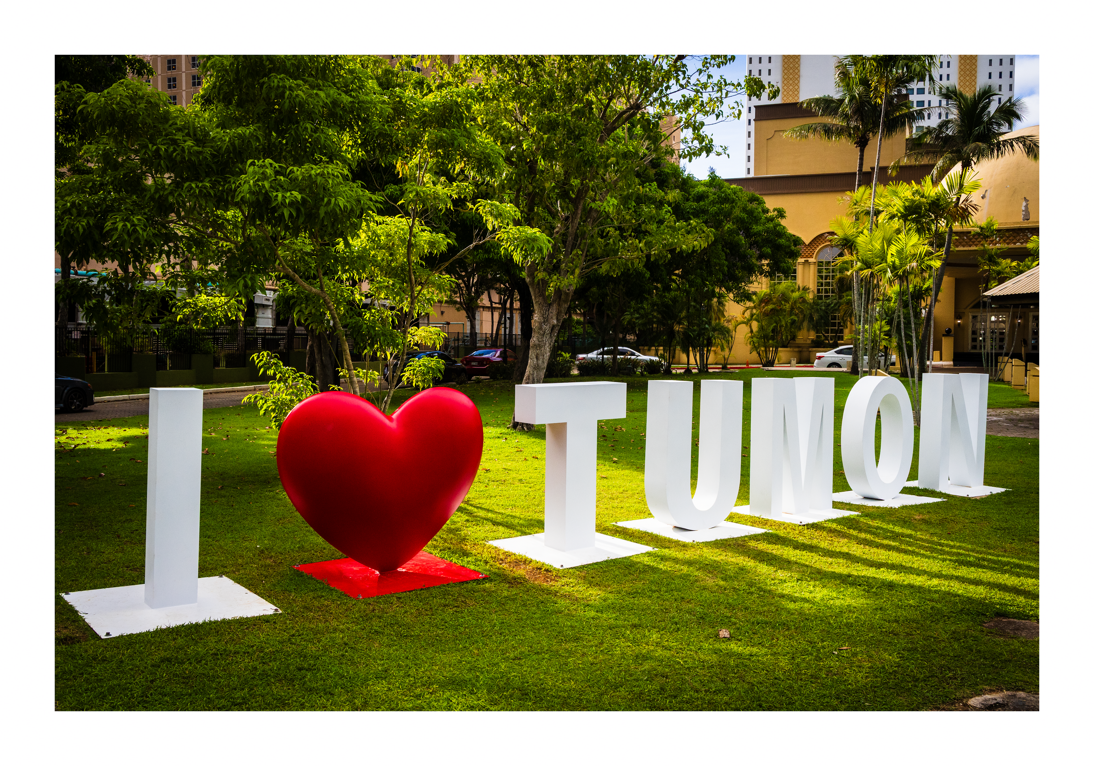 A 18x12 inch fine art travel print of the I Love Tumon landmark sign, showing product dimensions and clean white margins.