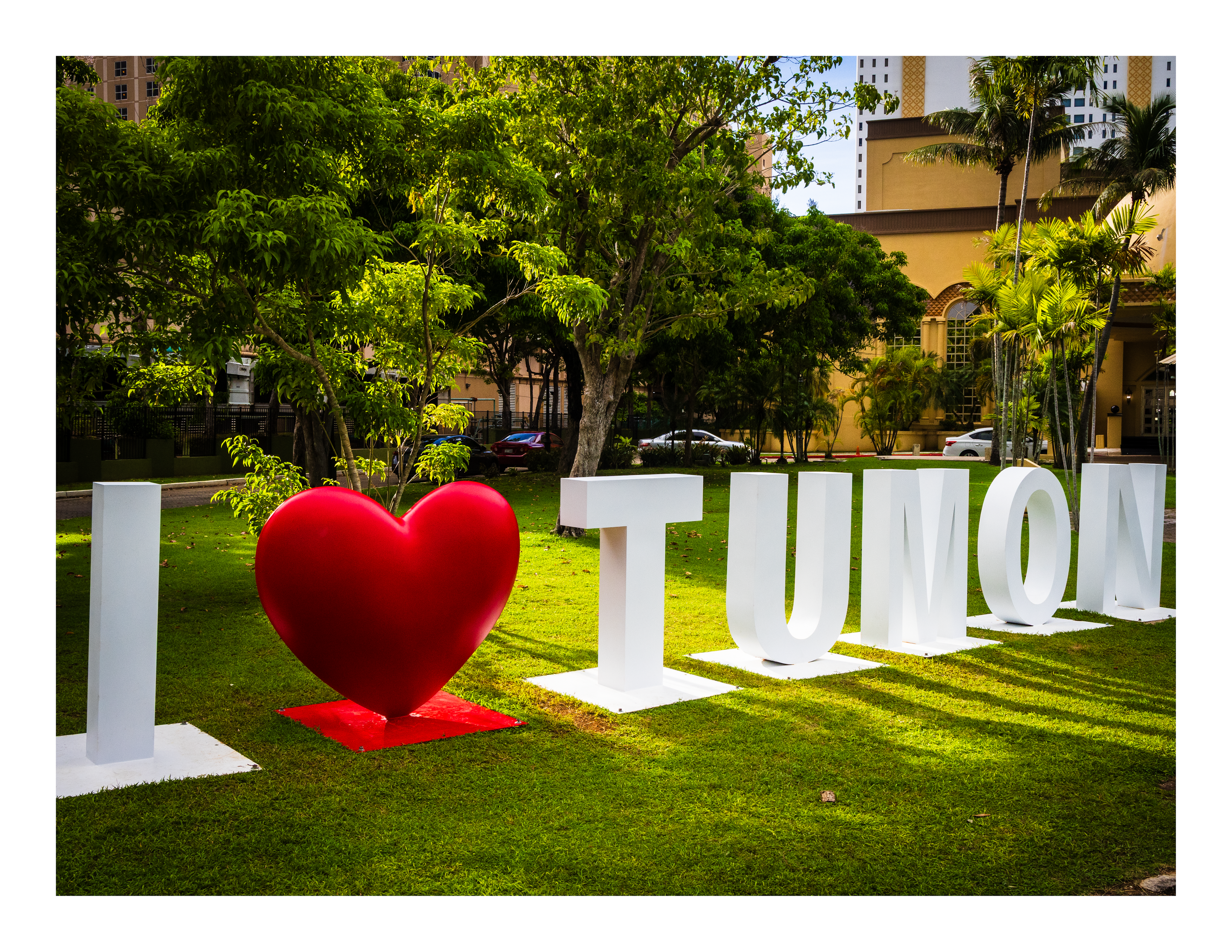 A 22x17 inch fine art travel print of the I Love Tumon landmark sign, showing product dimensions and clean white margins.
