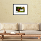A framed fine art travel print of the iconic I Love Tumon sign in Guam displayed on a living room wall over a couch to show scale.