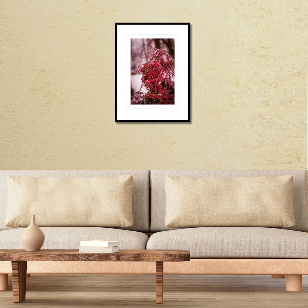 A framed macro nature photography print of ice-covered winter berries displayed on a wall above a couch to demonstrate scale.