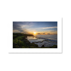 A serene sunrise over the Inalåjan Natural Pools in Guam, with the golden sun reflecting perfectly on the still, turquoise tide pools.
