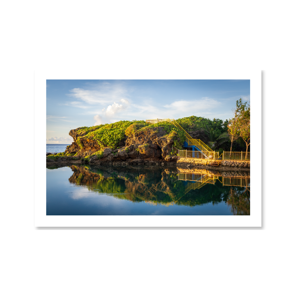 Fine art landscape photograph of the Inalåjan Natural Pools on the rugged coast of Guam, featuring volcanic rock formations.