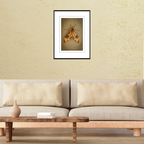 A framed macro wildlife photograph of a large hawk moth in Guam displayed on a living room wall above a couch to show scale.