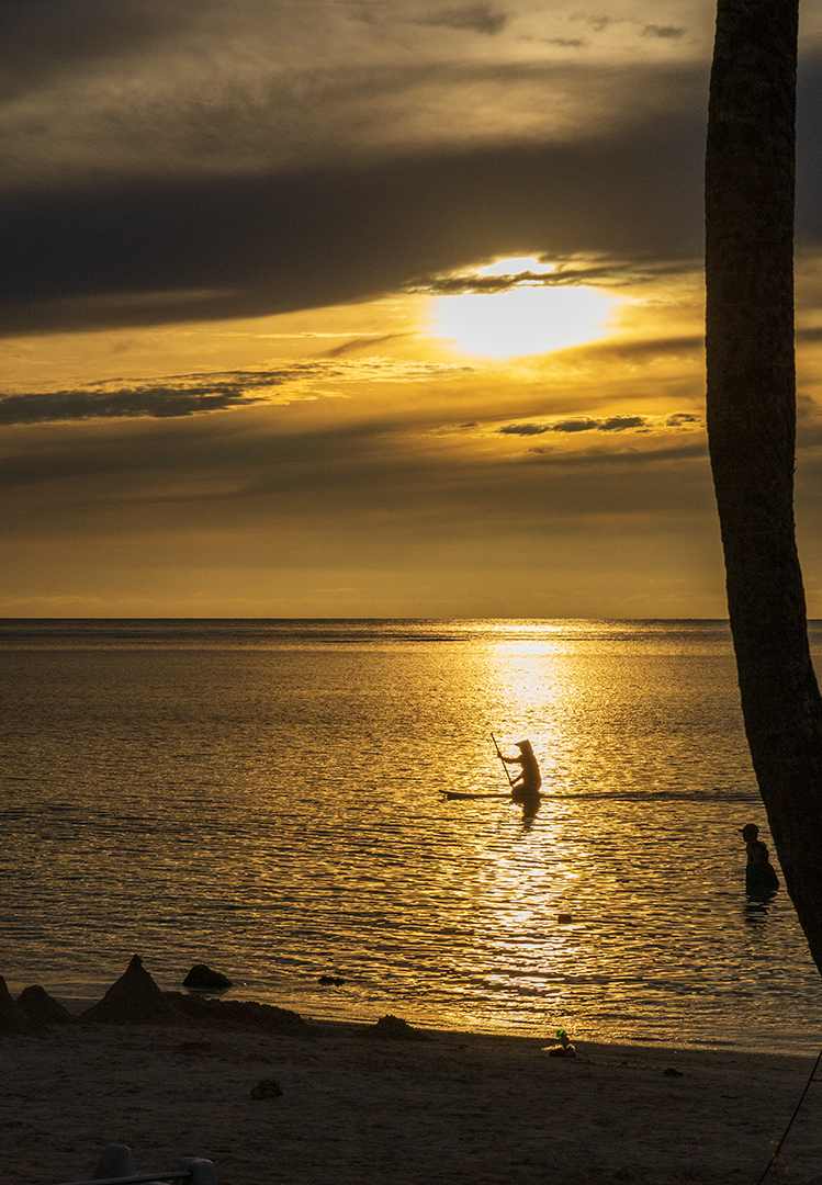 Final - This sunset shows the diversity of the play of light with the clouds. Compare it to the next print Palm Tree Sunset, which was taken on the same night. Here you see a kneeling paddleboarder emerging from behind a slim palm tree to glide across the glowing path of the sun.